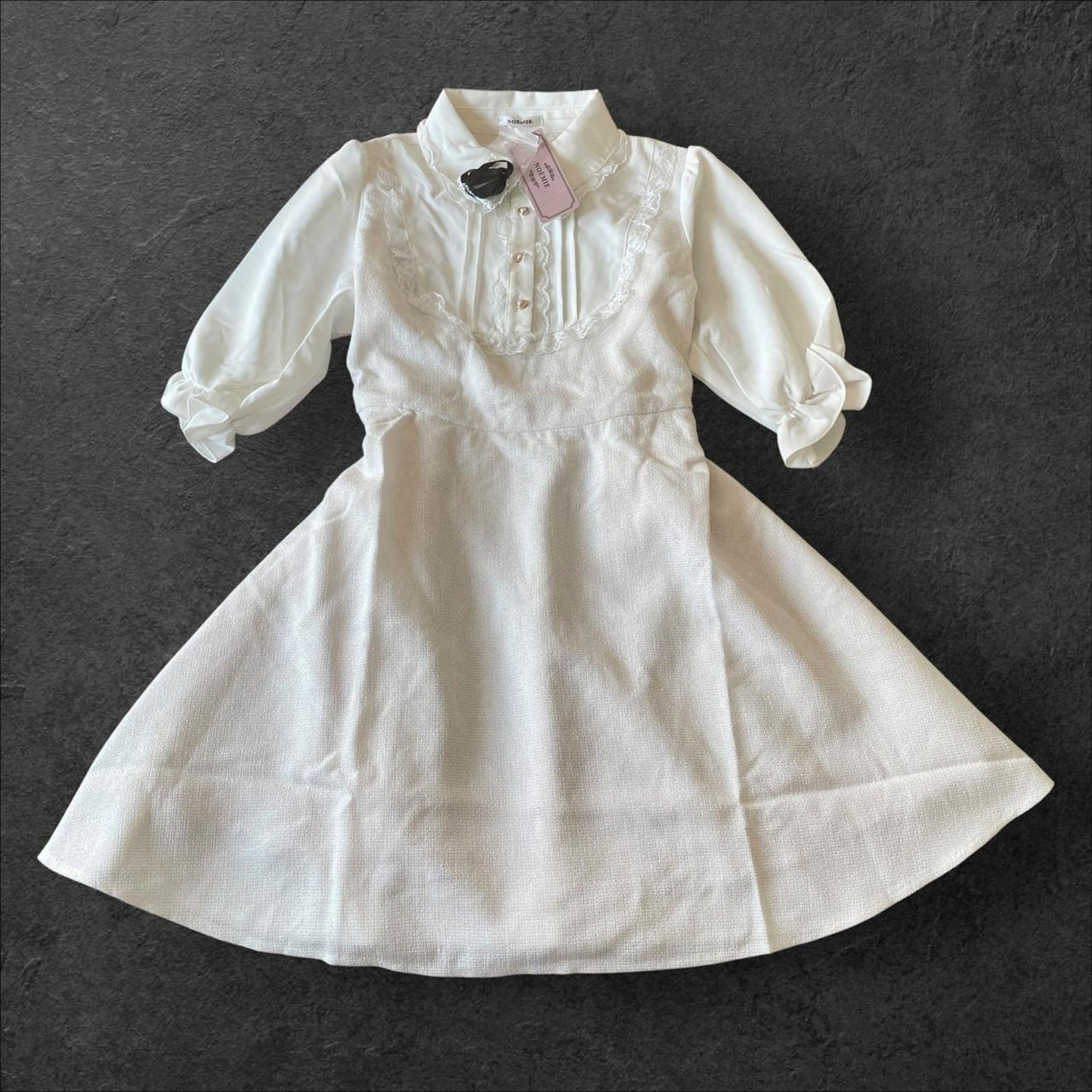 Noemie Jirai Kei ivory dress with a frilled high collar0