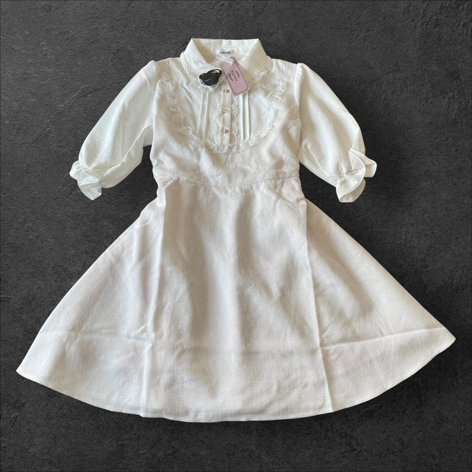 Noemie Jirai Kei ivory dress with a frilled high collar0