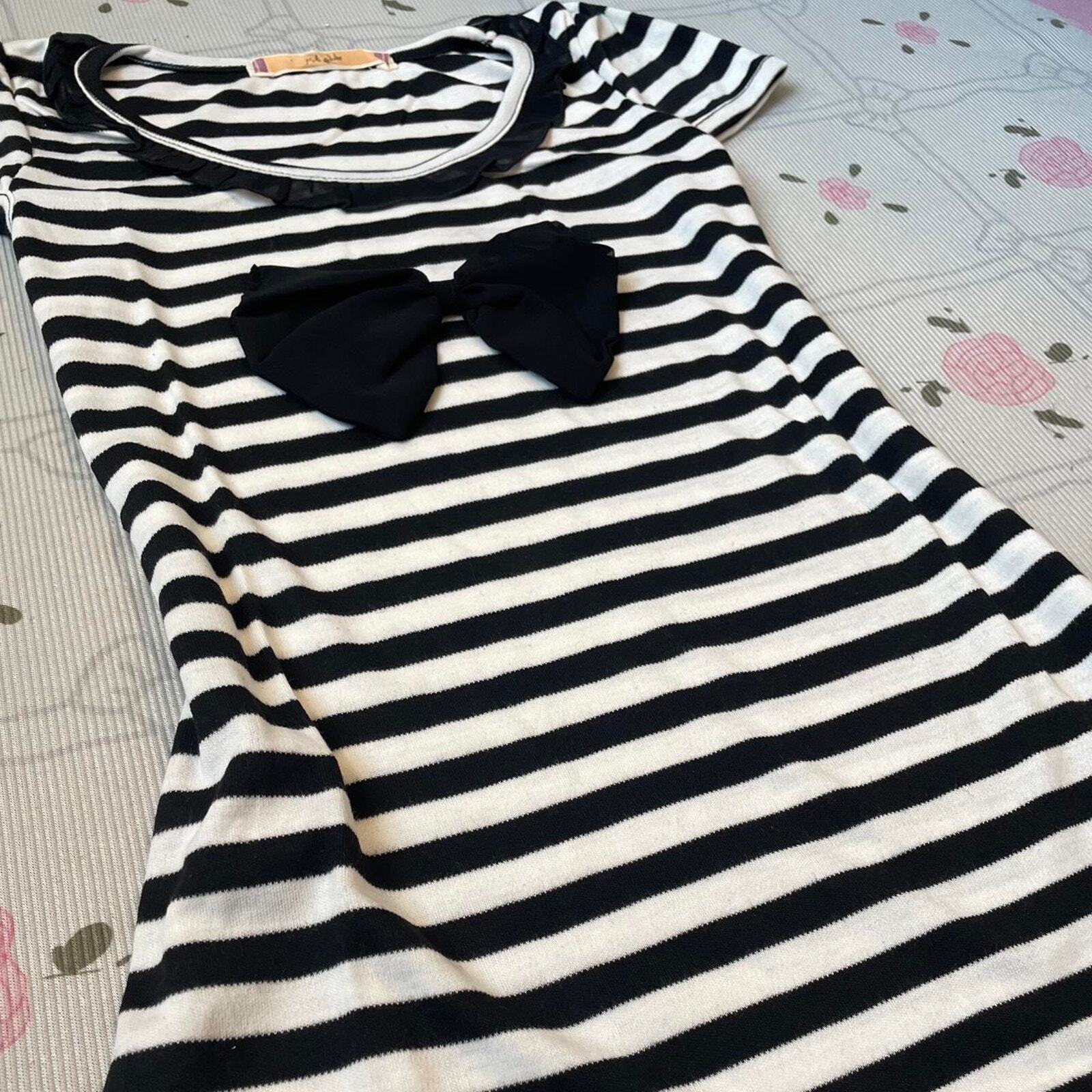 Black and white striped top with black bow and ruffled neckline 2