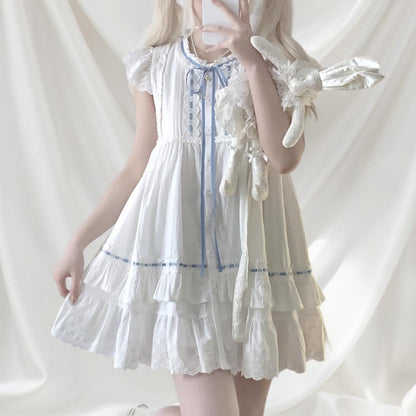 White cotton dress with blue ribbon and lace detail0