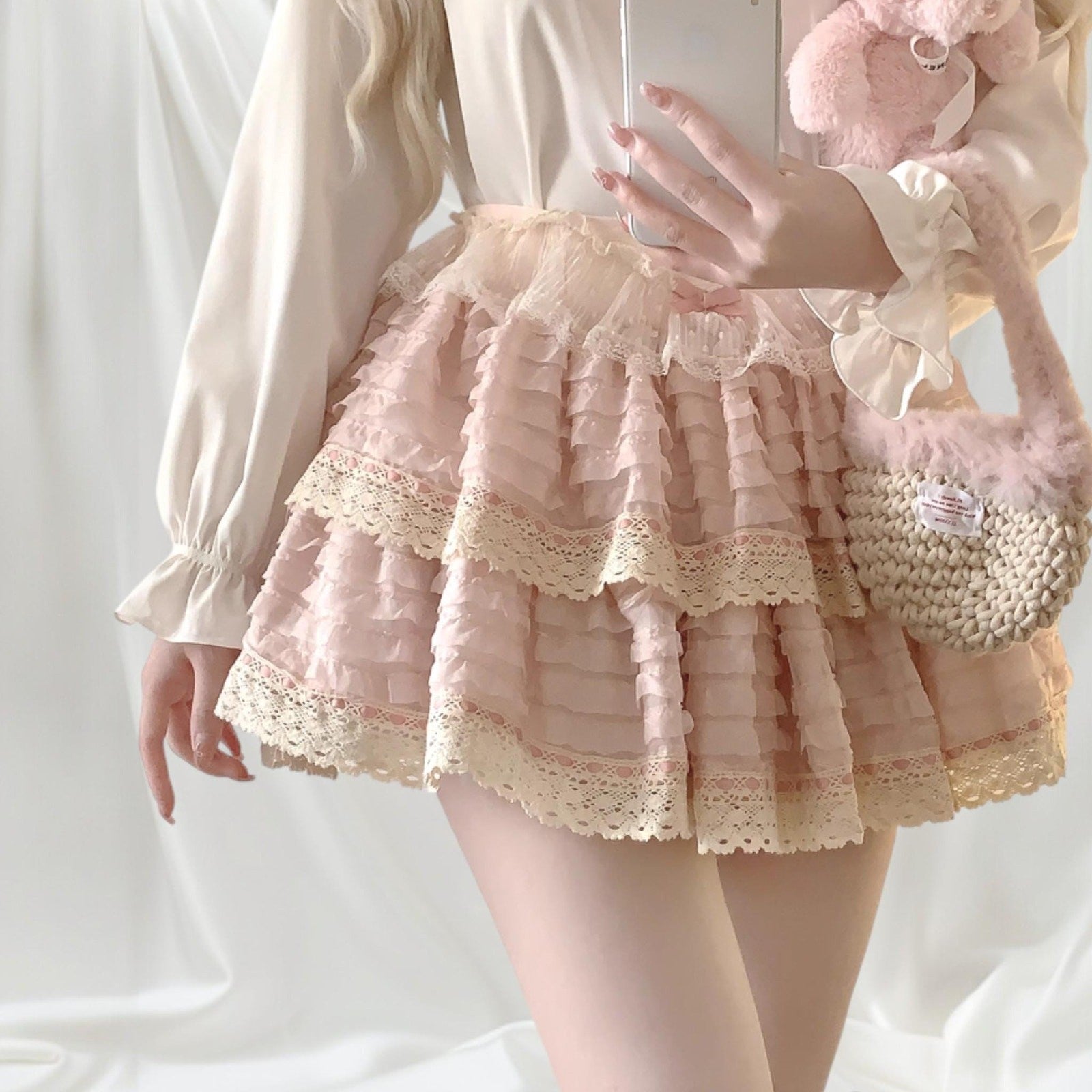Layered lace ruffle mini skirt with intricate lace trim in soft pink0