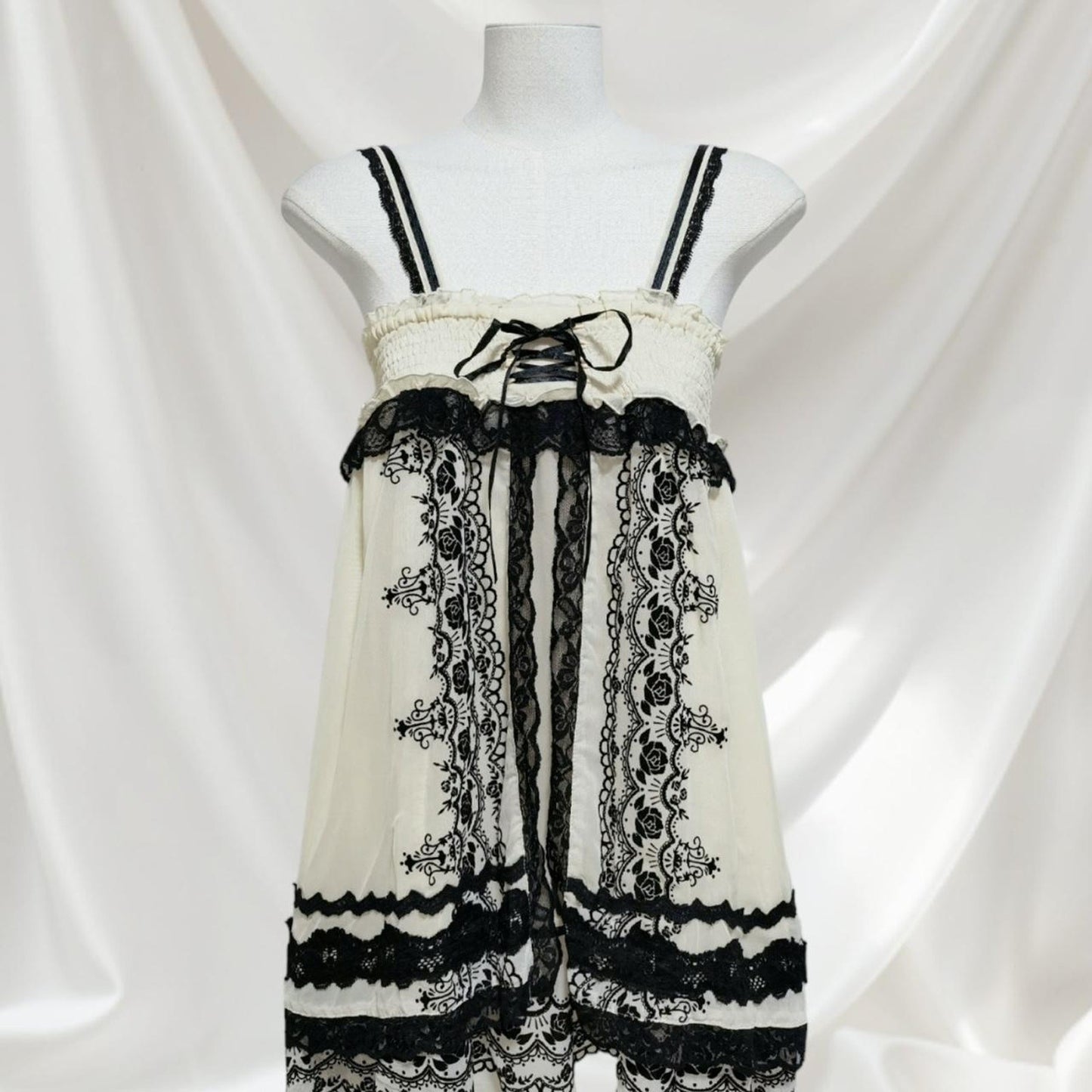 Axes Femme beige dress with rose pattern, laceup front and black lace detailing0