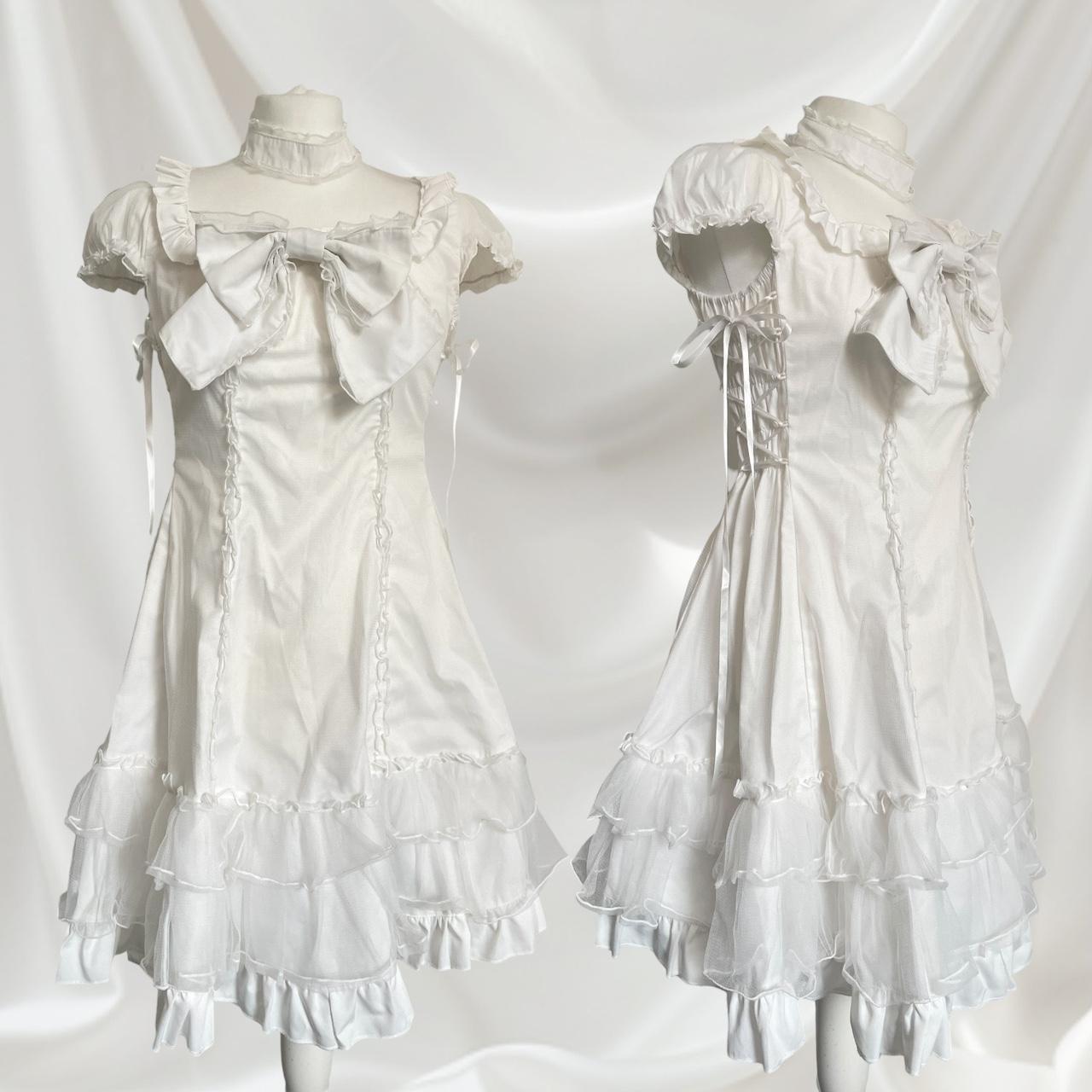 Bodyline white dress with a detachable bow and cross-tie detail0